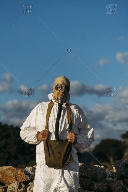 Man with tear gas mask and white scientist costume