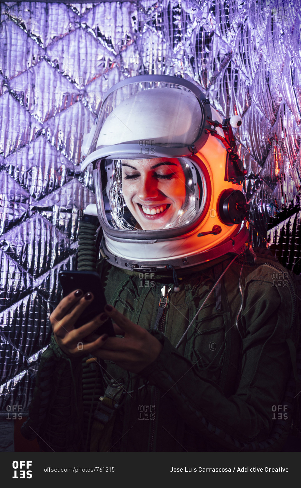 Beautiful female astronaut with mobile phone.