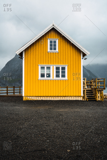 Yellow house with mountains behind