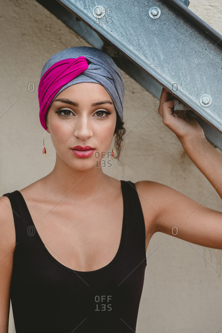 Woman in headscarf standing near ladder