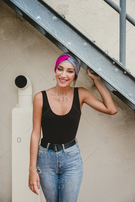 Woman in headscarf standing near ladder