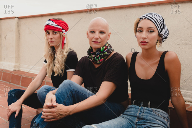 Women sitting on tile floor and smiling