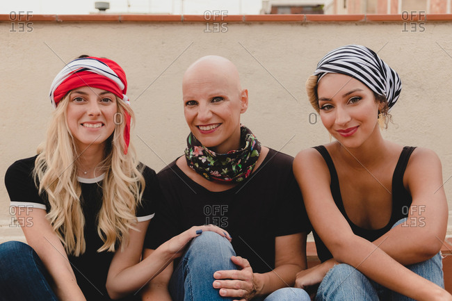Women sitting on tile floor and smiling