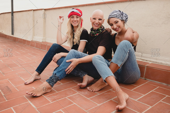 Women sitting on tile floor and smiling