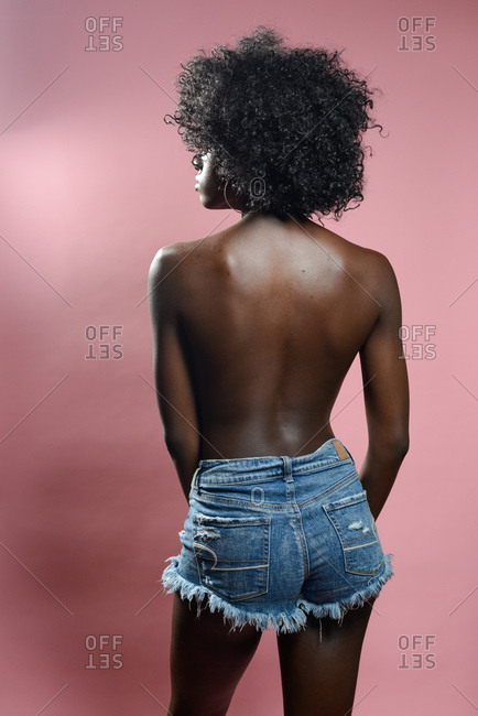 Topless African American model wearing short jean shorts