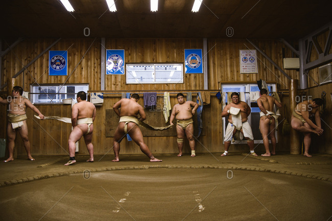 Japan, Niigata - October 25, 2017: Wrestlers getting dressed against wooden wall in sumo beya