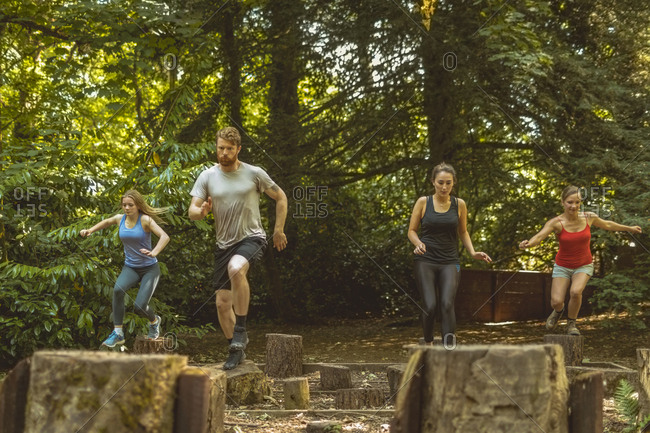 Fit people training over obstacle course at boot camp