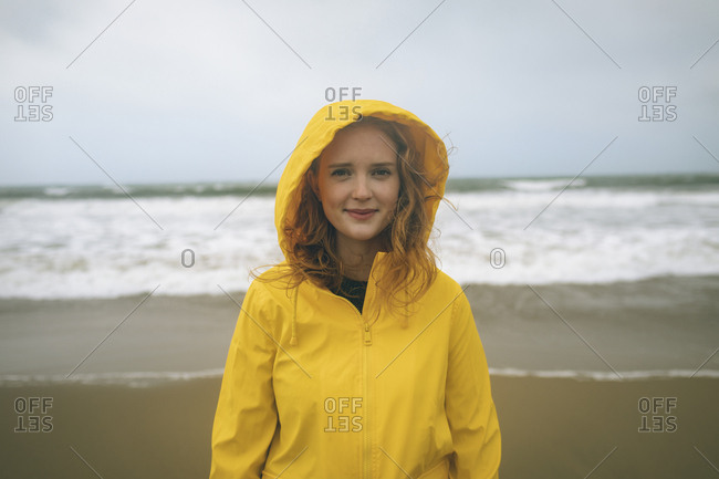 Portrait of redhead woman standing in the beach