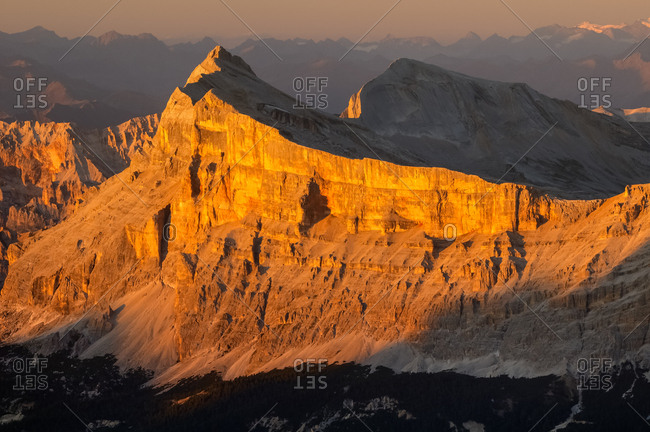 Sunset from the top of Piz Boe in the Sella mountain group towards Sasso della Croce peak, dolomites, Italy