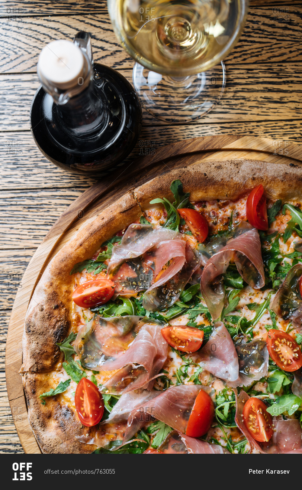 Gourmet pizza served with balsamic vinegar and white wine