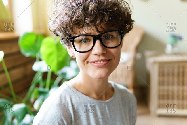 Portrait of woman with curly hair wearing retro glasses