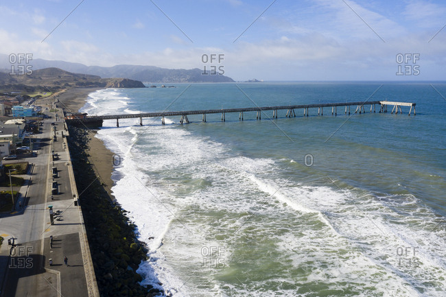 Aerial view of shoreline and distant mountains in Pacifica California