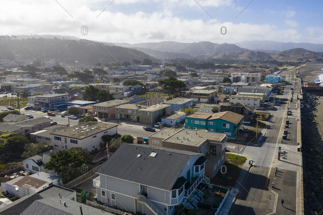 Aerial view of neighborhood and distant mountains in Pacifica California