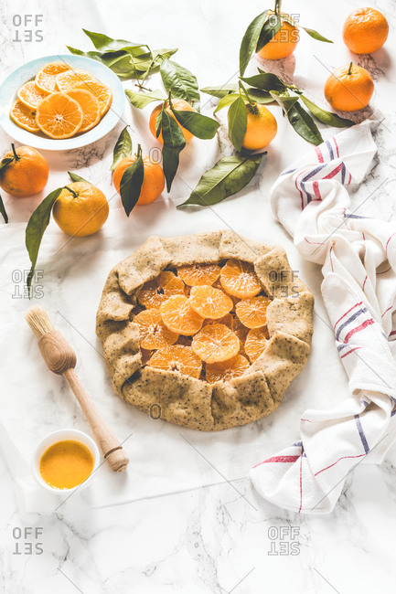 Winter citrus galette with clementine slices wrapped in raw dough