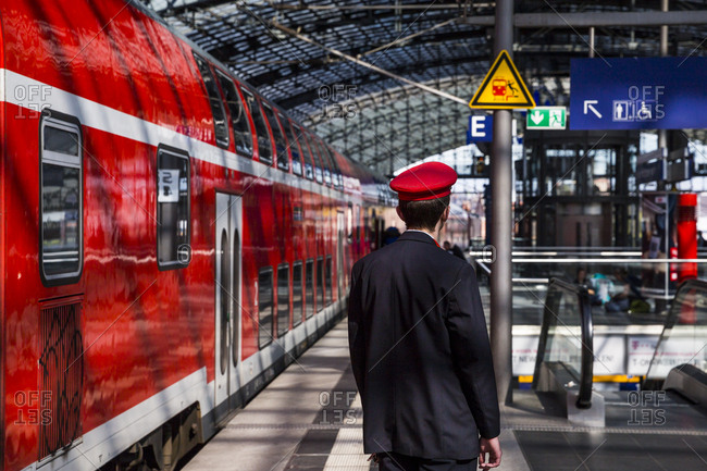A railway worker at work in the main train station (Hauptbahnhof), Berlin, Germany.
