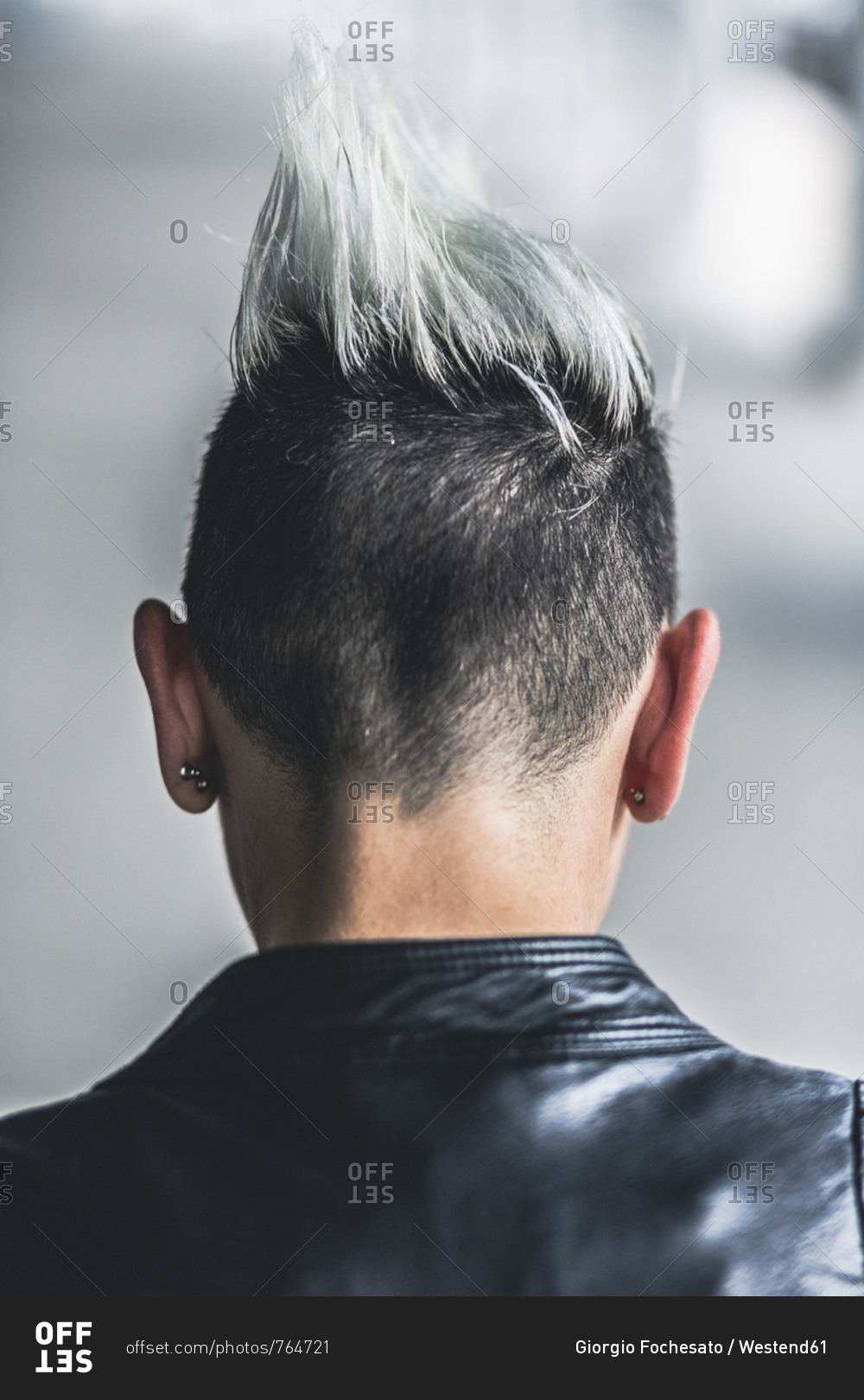 Rear view of punk woman with mohawk haircut stock photo - OFFSET