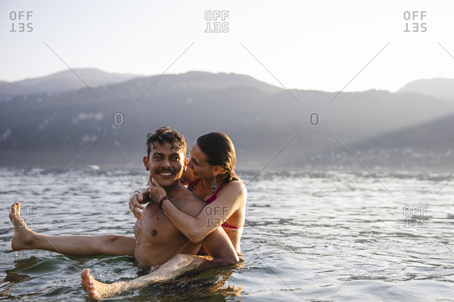 Happy playful young couple in a lake