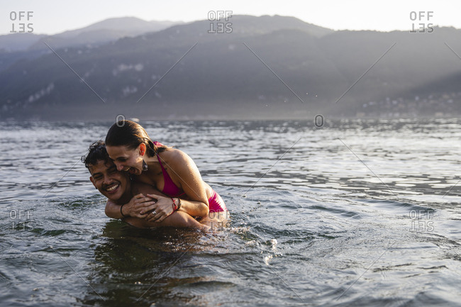 Happy playful young couple in a lake