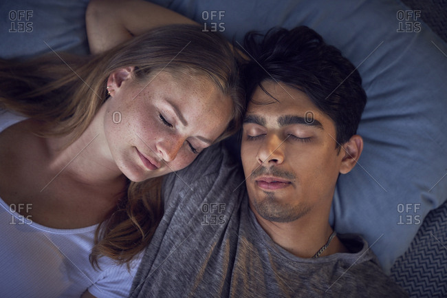 Young couple relaxing on cushions
