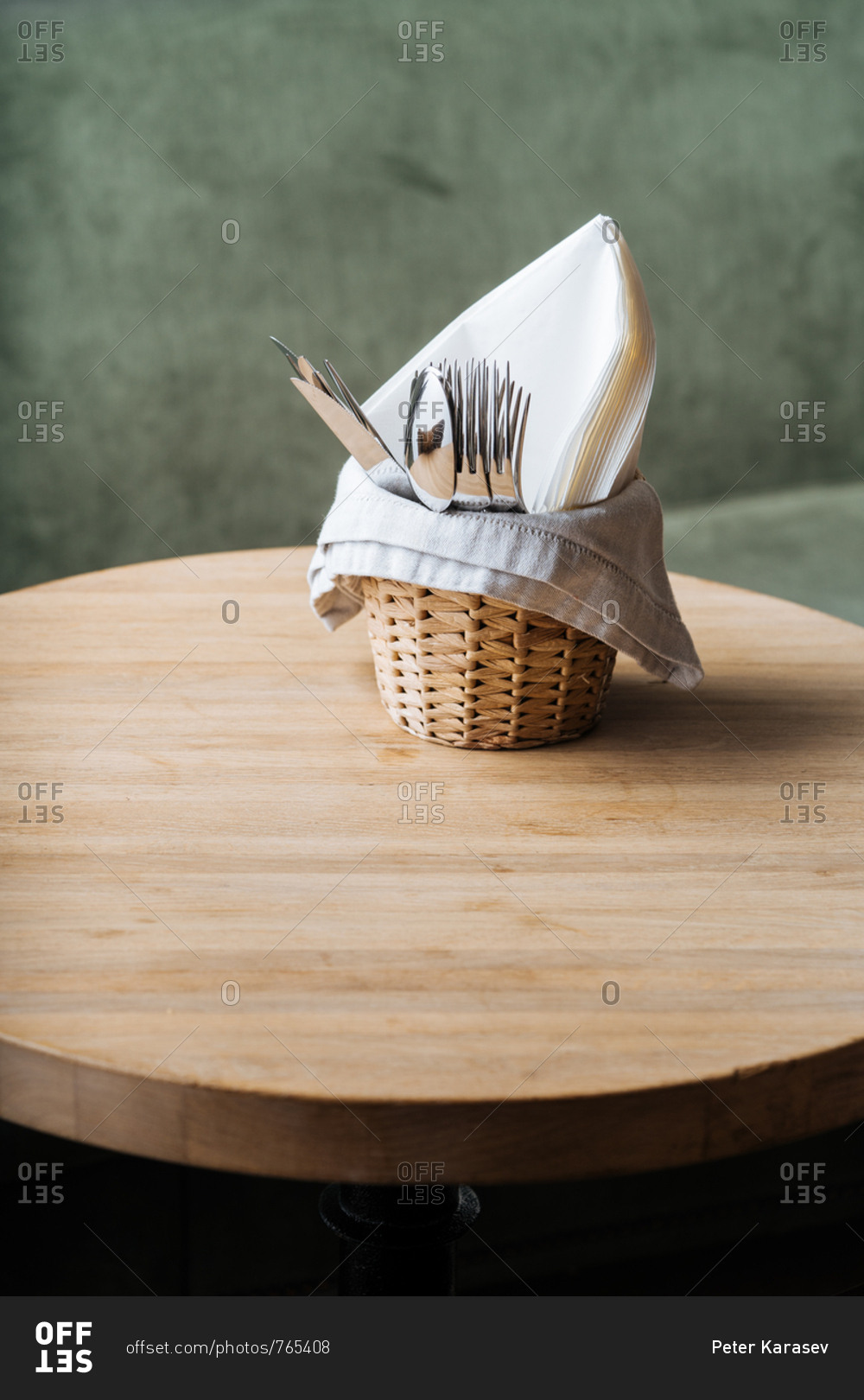 Basket of utensils on a sage green background
