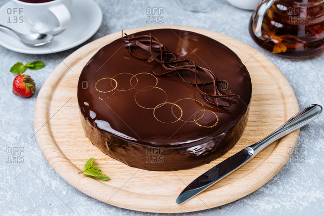 Overhead view of chocolate cake with decorative golden circles