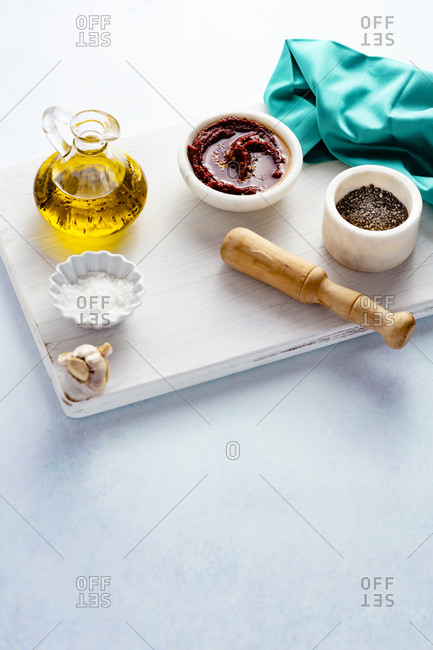 Various seasonings on a white wooden board