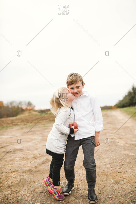 Little girl giving her brother a kiss
