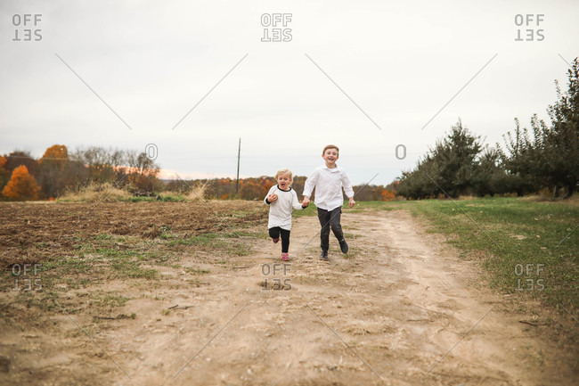 Siblings walking hand in hand