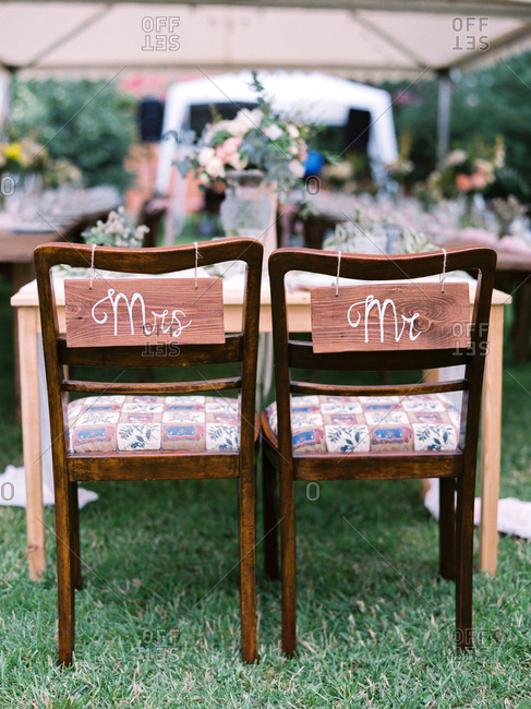 Bride and groom chairs at an outdoor wedding