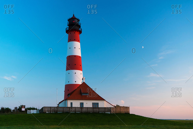Lighthouse Westerheversand with moon in the last evening light