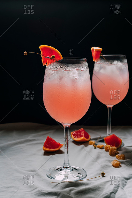 Cocktail grapefruit. Alcoholic beverage with tropical fruits lavender and ice flowers