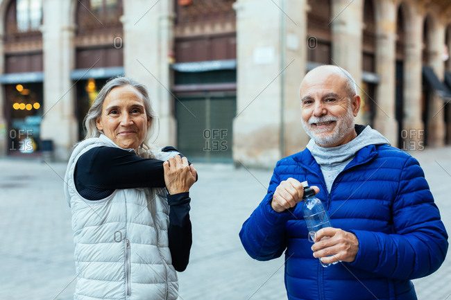 Senior couple taking a break after doing sport outdoors.