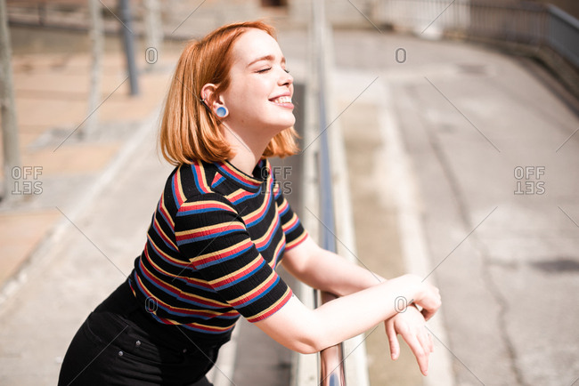 Portrait of a smiling young red haired woman soaking up the sunshine