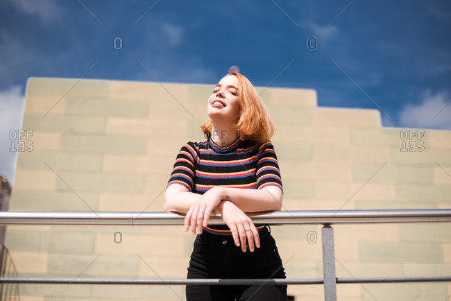 Portrait of a young red haired woman soaking up the sunshine