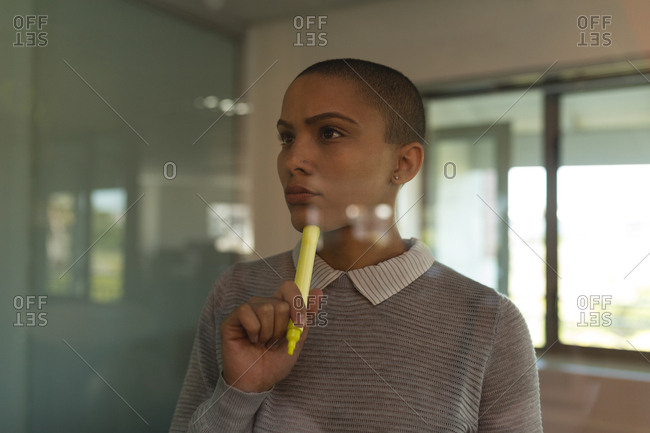 Thoughtful female business executive in office