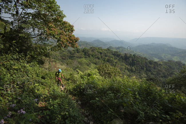 One man hikes on a trail at the area of Los Limones in Xicotepec de Juarez, Puebla, Mexico.