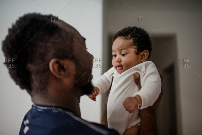 Father happily gazing at newborn baby