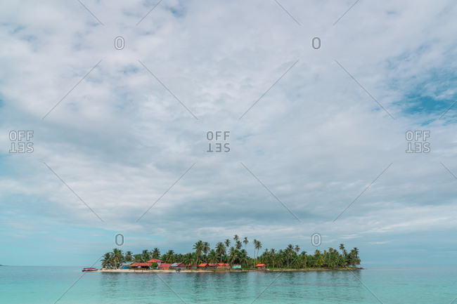 View of small island with houses in blue water far away in ocean, Panama