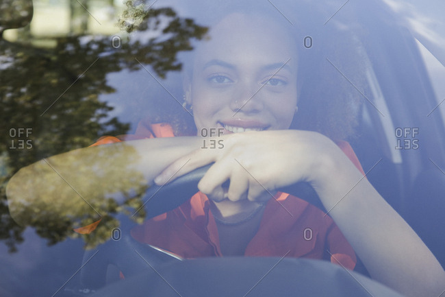 Portrait confident young woman driving car