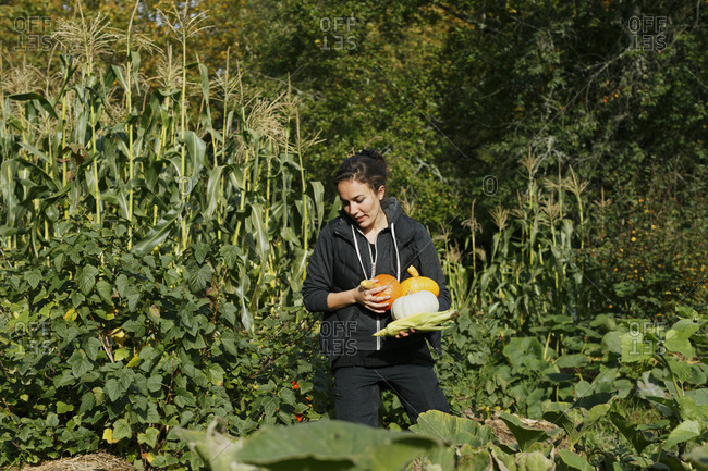 Woman holding freshly picked vegetables