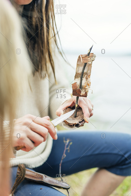 Woman making a tree bark boat in Finland