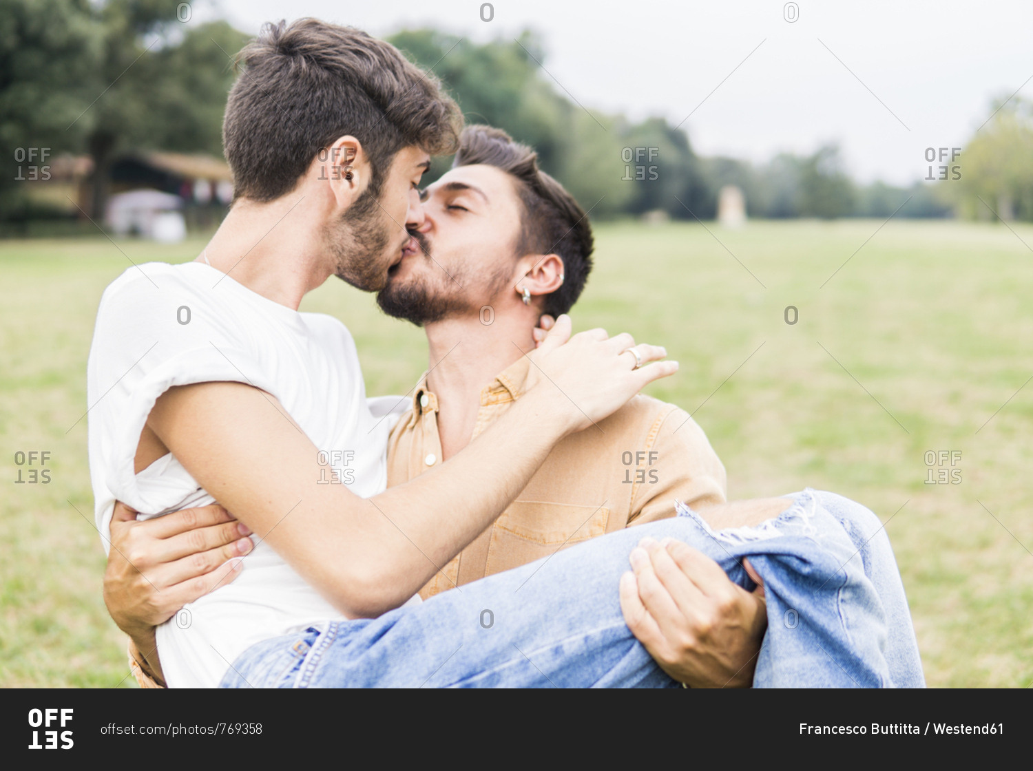 Young homosexual couple talking about renovation plans in their new home high