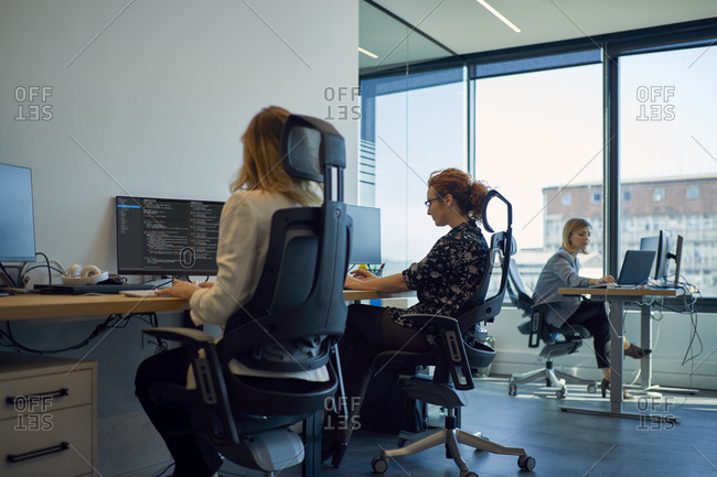 Businesswomen using computers in office