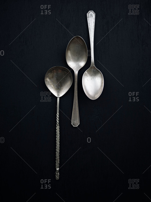 Three spoons on black background