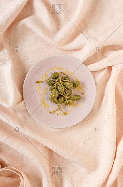 Capers in vinegar with olive oil and salt. Top flay; top view