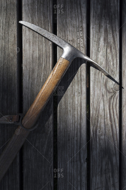 Old ice pick with wooden handle on a wooden table