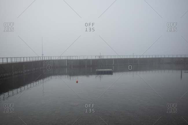 Marina surrounded by pier on a foggy day