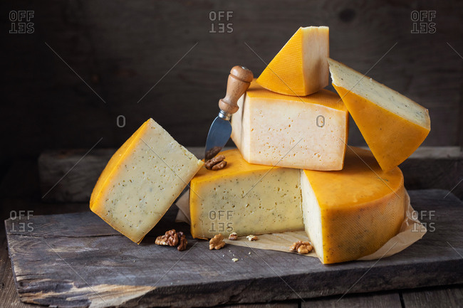 homemade cheese over on old wooden table. rustic background dark moody photo