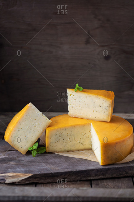 homemade cheese over on old wooden table. rustic background dark moody photo
