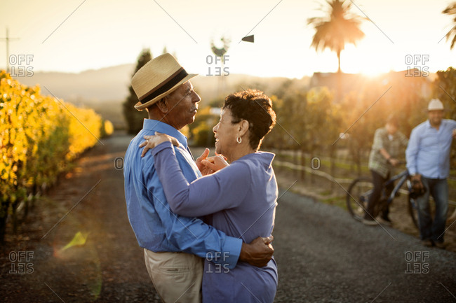 Senior couple dancing in the vineyard.